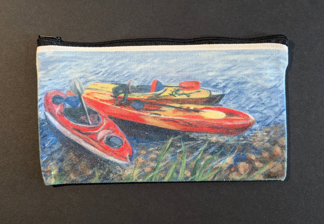 Pouch with a design of kayaks on a grassy bank with water background