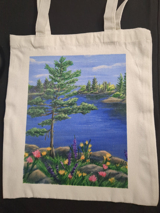 Tote bag with a nature scene of trees and flowers on a dark background