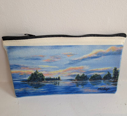 Pouch with a painted landscape of a lake and trees on a white background