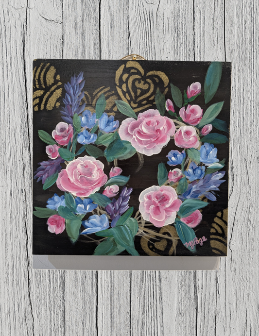Floral design on a black background with decorative elements on a wooden surface