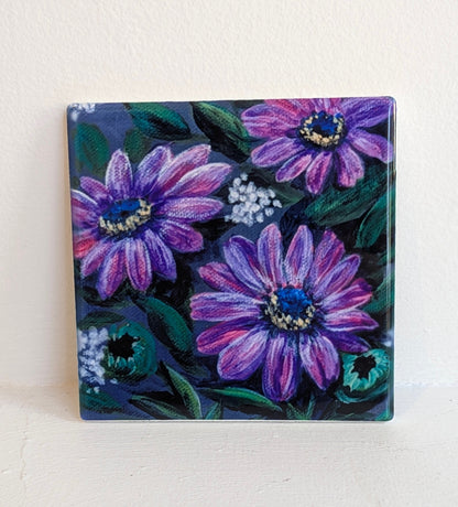 Square tile with a floral design featuring purple flowers.