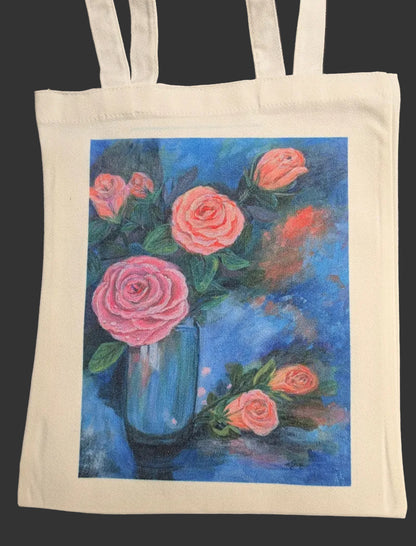 Tote bag with a painting of pink roses in a blue vase on a black background