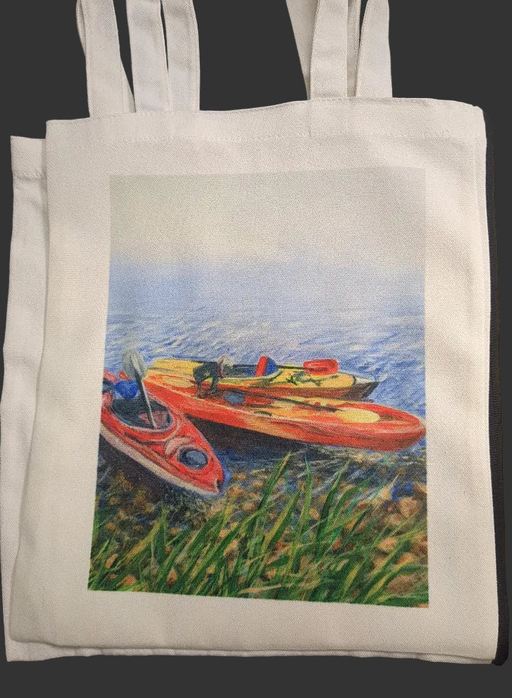 White tote bag with a printed design of three kayaks on water.