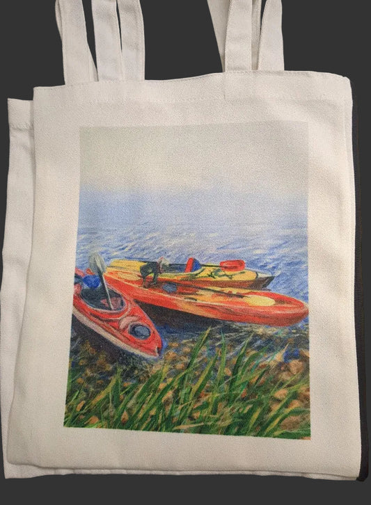 White tote bag with a printed design of three kayaks on water.